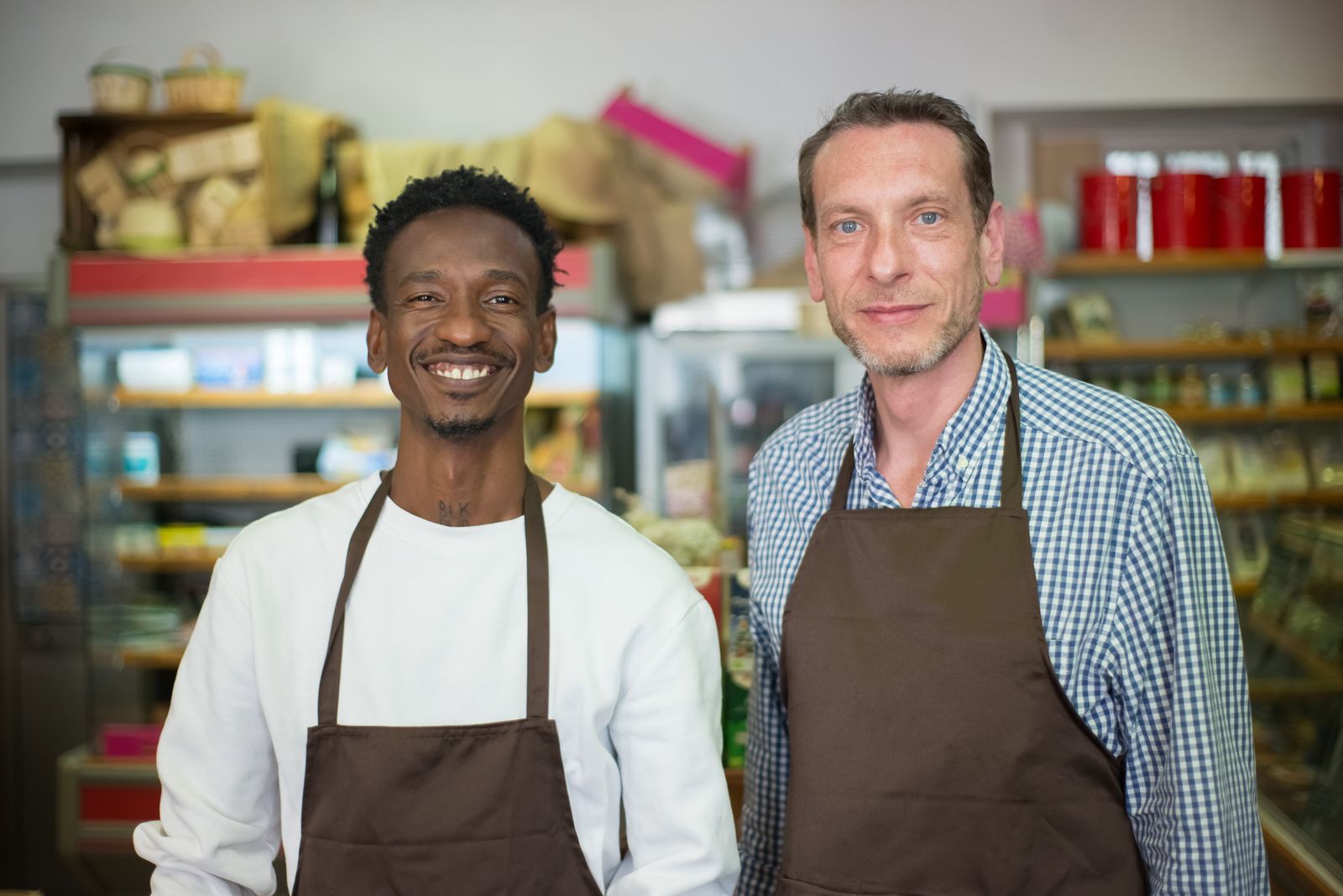 Two shop owners behind the counter, loyalty earns across every store on the network