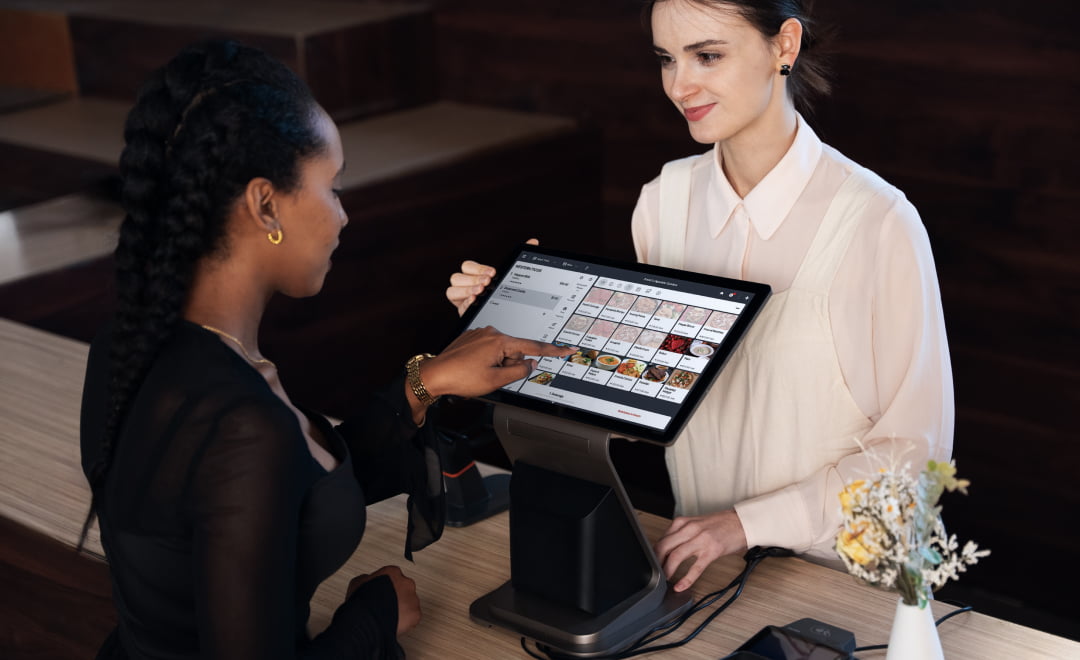 Owner showing live sales on the dual-screen PandazTech Terminal